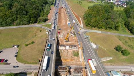 Construction-site-of-third-bridge-over-Neris-river-in-Kaunas,-aerial-view