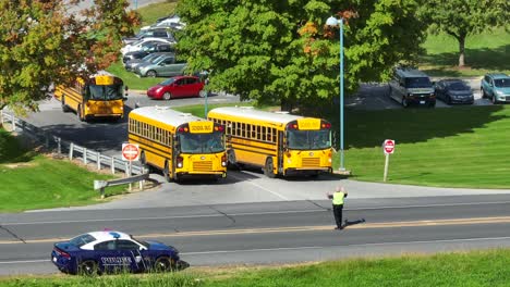 Aerial-view-of-yellow-school-buses-exiting-American-school