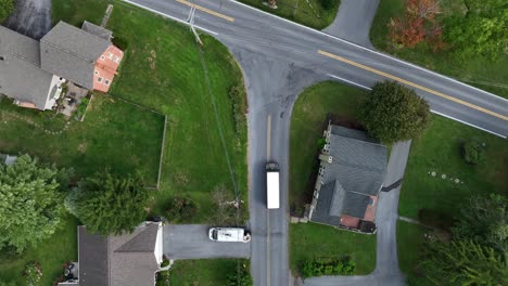 Top-down-aerial-tracking-shot-of-UPS-delivery-truck-with-white-roof
