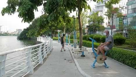 Local-elderly-Vietnamese-men-exercising,-West-Lake,-Tay-Ho,-Hanoi,-Vietnam