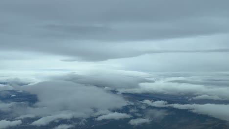 Dramatic-winter-sky-plenty-of-snow-clouds,-as-seen-by-the-pilots-in-a-real-flight