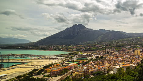 La-Belleza-De-Sicilia-Cobra-Vida-En-Una-Vista-De-Paisaje-En-Cámara-Rápida-Que-Muestra-Nubes-Cayendo-En-Cascada-Sobre-Las-Montañas,-Casas-Coloridas-Y-El-Sereno-Océano.