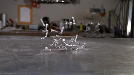 Screws-hitting-a-metal-surface-in-super-slow-motion