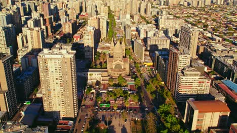 Aerial-view-of-the-residential-neighborhood-of-downtown-Santiago,-Iglesia-de-los-Sacramentinos-surrounded-by-buildings-of-different-heights,-Chile