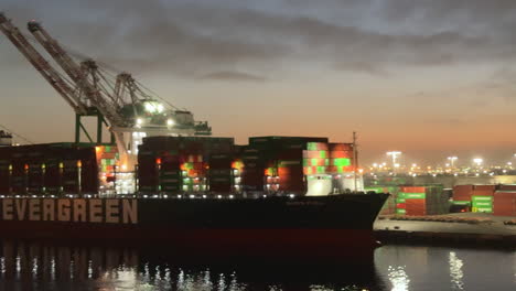 Nighttime-cargo-container-ship-at-illuminated-commercial-shipping-dock