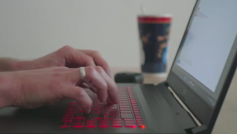 Business-Man-Writing-an-Email-on-a-Laptop-in-his-Homeoffice-Close-Up