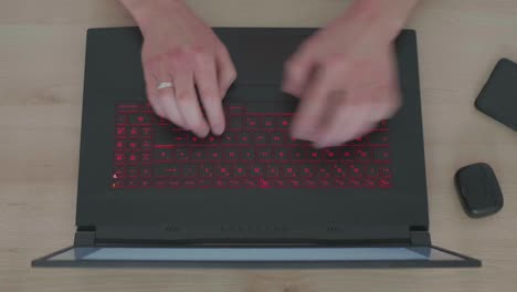 Top-View-of-Business-Man-Working-on-a-Laptop-in-his-Homeoffice-Using-a-Touchpad