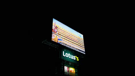 Advertisement-of-a-supermarket-going-on-Lotus's-Super-Market-LED-Billboard-with-KFC,-MK,-Pizza-Company