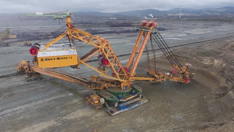 Aerial-view-of-heavy-mining-machine-extract-natural-resources-in-open-pit