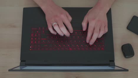 Top-View-of-Business-Man-Writing-an-Email-on-a-Laptop-in-his-Homeoffice