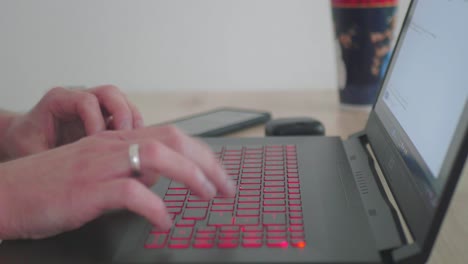 Business-Man-Working-on-a-Laptop-in-his-Homeoffice-Using-a-Touchpad-Close-Up