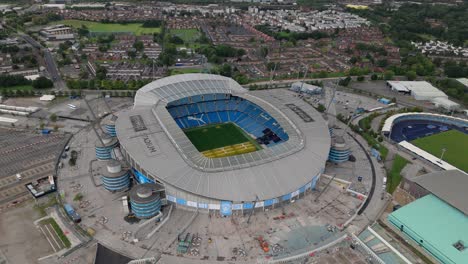 Manchester-City-Football-Club-at-Etihad-Stadium,-high-angle-aerial-arc