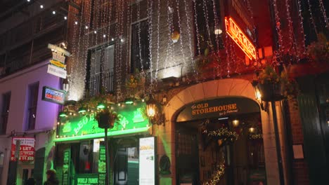 Tilt-shot-Old-warehouse-in-Crown-Alley-at-Christmas-season-at-night-in-Dublin,-Ireland