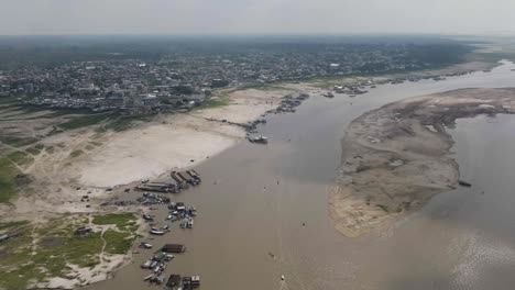 AMAZON-DROUGHT---Small-town-in-the-middle-of-the-amazon-rainforest-aerial-shot-showing-dry-river-with-sand-accumulation-as-water-levels-drop---climate-change-problem