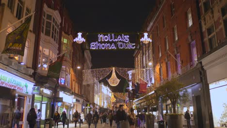 Tilt-shot-of-Christmas-street-with-decorations-in-Dublin,-Ireland