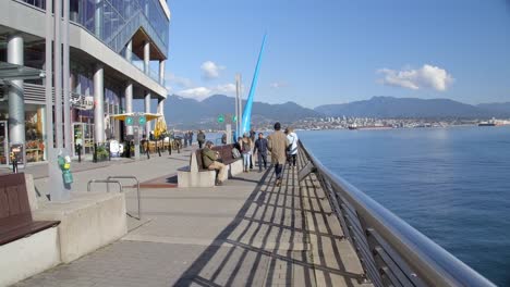 People-At-The-Bon-Voyage-Plaza-With-The-Drop-Sculpture-In-Vancouver,-BC,-Canada