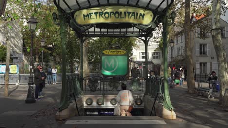 People-Going-into-Metropolitain-Subway-Entrance-in-District-of-Montmartre-in-Paris-on-Early-Autumn