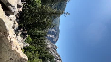 Nevada-Falls-waterfall-falling-over-a-rocky-cliff-in-Yosemite,-establishing-vertical-view