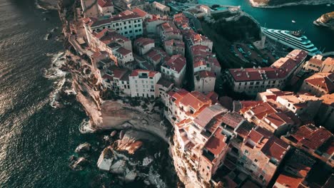 aerial,-drone-flying-above-Bonifacio-at-sunset,-Corsica