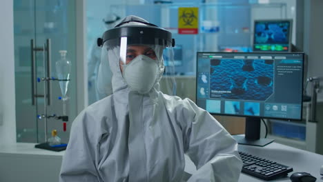 Overworked-woman-chemist-in-coverall-looking-tired-at-camera