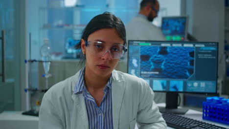 Exhausted-microbiologist-with-protection-glass-looking-at-camera