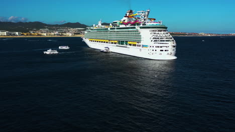 Aerial-view-around-a-cruise-ship-on-the-coast-of-sunny-Cabo-San-Lucas,-Mexico