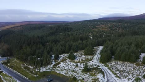Winter-Serenity:-Aerial-View-of-Families-Enjoying-Snowy-Fun-on-an-Empty-Road-Amidst-Wicklow-Mountains