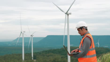 Progressive-concept-of-engineer-working-in-the-wind-farm-atop-of-the-mountain.