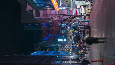 Busy-Crowded-Street-of-Myeongdong-Night-Market-with-Tourists-Traveling---Vertical-Dynamic-Pan-Time-Lapse