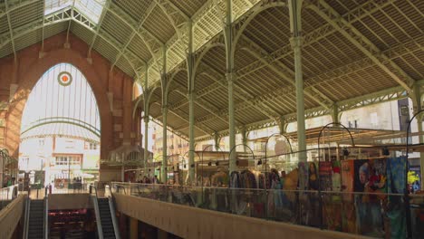 Local-Shops-Inside-The-Mercado-de-Colon-With-Escalators-In-Valencia,-Spain