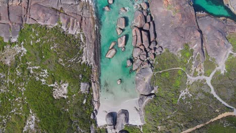 Top-down-view-of-water-flowing-into-Elephant-Rocks,-Western-Australia