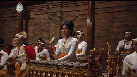 Indonesian-Women-Play-Music-in-Bali,-Gamelan-Orchestra-with-Ceremonial-Clothes