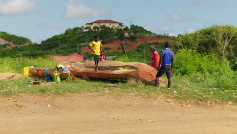 Bored-black-african-guys-fooling-around-by-dirt-road-in-poor-Ghana