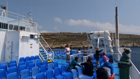 Ferry-with-blue-seats-and-tourists-taking-photos-of-surroundings