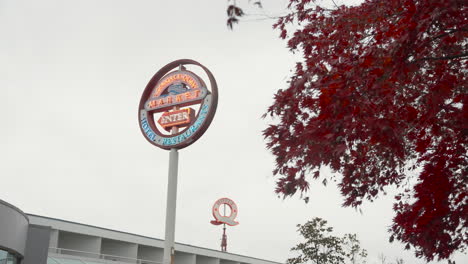 A-left-to-right-dolly-shot-captures-a-neon-sign-reading-'Lonsdale-Quay-Market,'-with-a-smaller-Q-shaped-sign-reading-'Hotel'-in-the-background