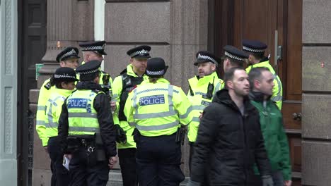 MET-police-officers-gather-outside-the-Royal-Courts-of-Justice-in-London,-UK