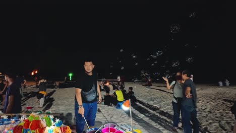 people-joyfully-experiencing-the-serene-beauty-of-Langkawi's-Pantai-Cenang-beach-at-night