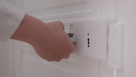 Woman's-hand-trying-to-open-a-locked-door
