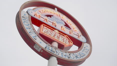 A-slow-right-to-left-orbiting-shot-captures-the-full-view-of-a-red-and-white-sign,-proudly-displaying-'Lonsdale-Quay-Market