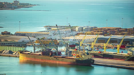 Unloading-a-cargo-ship-at-the-dock-at-Malaga,-Spain---time-lapse