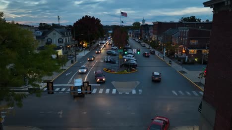 Traffic-driving-in-town-square-at-night