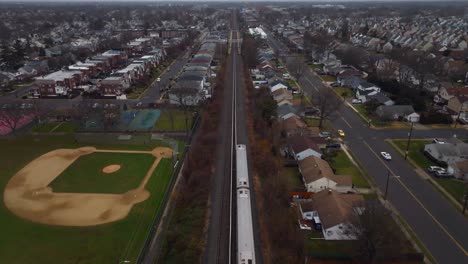 An-aerial-view-of-a-Long-Island-railroad-train-traveling-on-a-cloudy-day