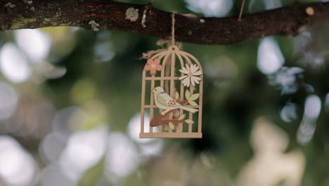 Artistic-wooden-birdcage-amidst-blurred-foliage