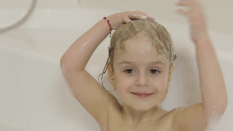 Attractive-three-years-old-girl-takes-a-bath.-Cleaning-and-washing-hair