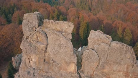 Newlyweds-stand-on-a-high-slope-of-the-mountain.-Groom-and-bride.-Arial-view