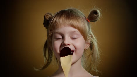 Playful-teen-child-kid-girl-eating,-licking-melted-chocolate-sweet-candy-syrup-from-wooden-spoon