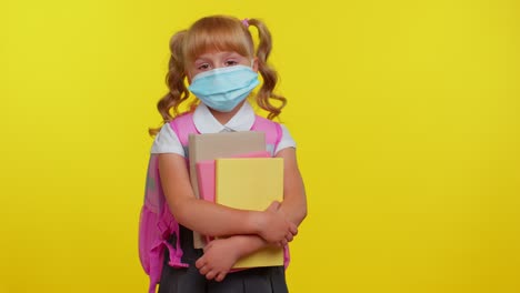 Unhealthy-teen-schoolgirl-kid-wearing-protective-medical-mask,-standing-with-books-looking-tired