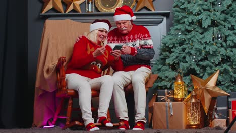 Großmutter-Einer-älteren-Familie,-Die-Mit-Kreditkarte-Und-Smartphone-Weihnachtsgeschenke-Einkauft