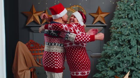 Happy-senior-old-family-couple-grandmother-grandmother-embracing-at-decorated-Christmas-home-room