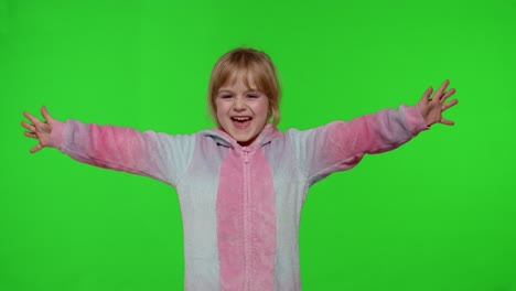 Little-blonde-child-girl-smiling,-dancing,-celebrating-in-unicorn-pajamas-costume-on-chroma-key